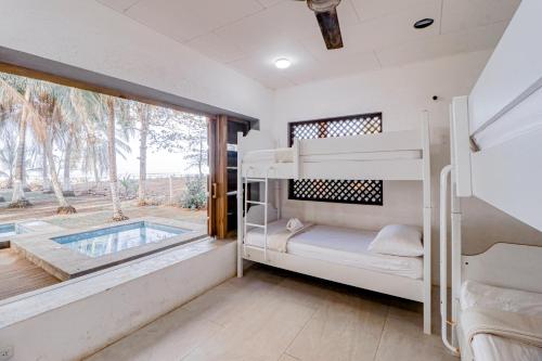 a bedroom with bunk beds and a swimming pool at Mangue House in Playa San Miguel 