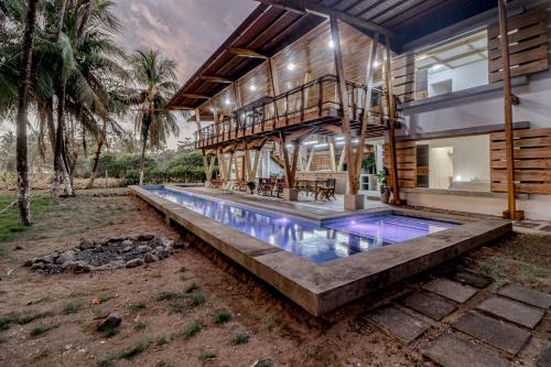 an exterior view of a house with a swimming pool at Mangue House in Playa San Miguel 