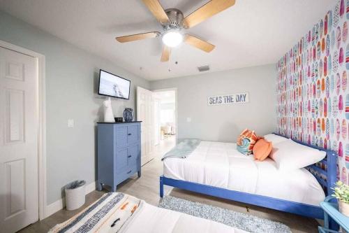 a bedroom with a bed and a ceiling fan at Beach house w/Putting Green/Game Rm/Rooftop Deck in Cocoa Beach