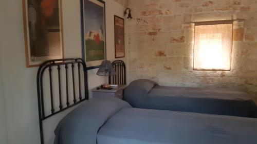 מיטה או מיטות בחדר ב-Casa alle vigne