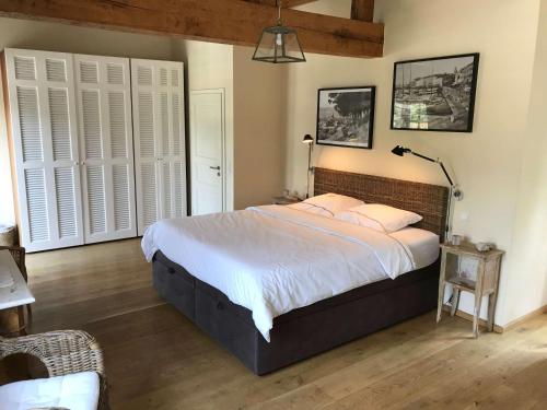 a bedroom with a large bed with white sheets at Villa La Begude - Boutique B&B in Saint-Tropez