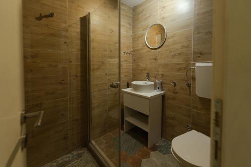 a bathroom with a toilet and a sink and a shower at Sleep Hostel in Niš