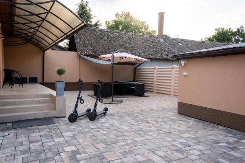 a scooter is parked in the courtyard of a garage at Kolibri Apartman - Makó in Makó