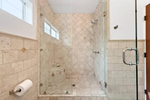a bathroom with a shower with a glass door at Beverly Grove Spanish Oasis with Pool & Parking in Los Angeles