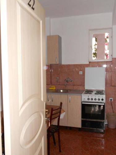 a kitchen with a table and a stove top oven at Kuća Todorović in Budva