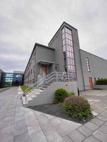 a building with a staircase in front of it at Student Hostel in Reykjavík