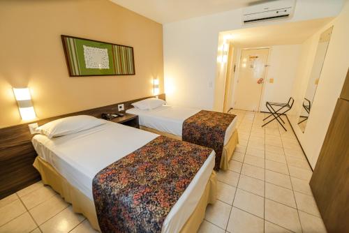 Ένα ή περισσότερα κρεβάτια σε δωμάτιο στο Hotel Sonata de Iracema