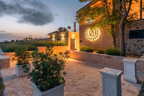 a house with lights on the side of it at Vidikovac Levanda Luxury Apartments in Hvar