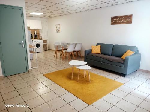 sala de estar con sofá y mesa en Le petit Cosy en Saint-Laurent-de-la-Salanque
