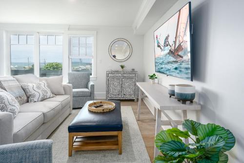 a living room with a couch and a table at Thomas Sea Suites at Harbourtown in Plymouth