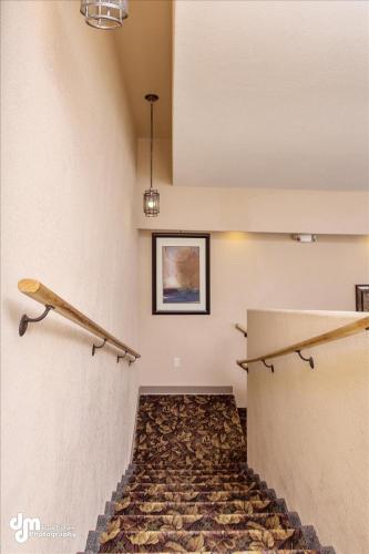 a room with a staircase with two wooden racks on the wall at Kenai Airport Hotel in Kenai