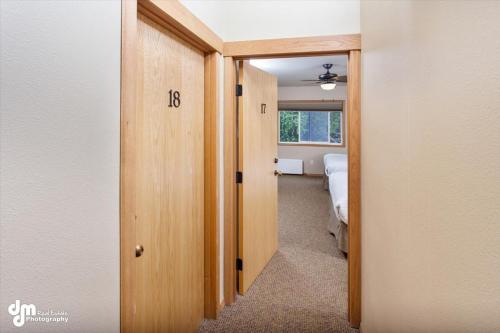 a hallway leading to a bedroom with a bed in it at Kenai Airport Hotel in Kenai