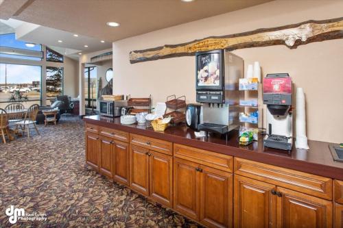 a hotel lobby with a counter with a coffee shop at Kenai Airport Hotel in Kenai