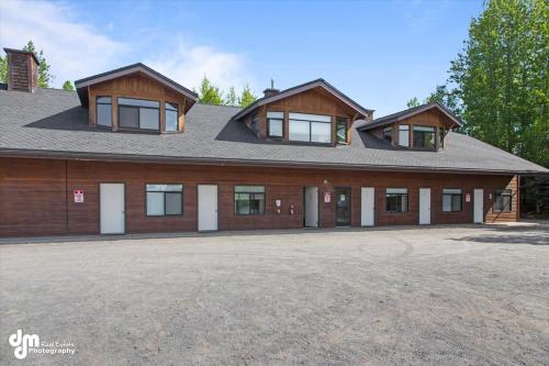 a large house with a gambrel roof at Kenai Airport Hotel in Kenai