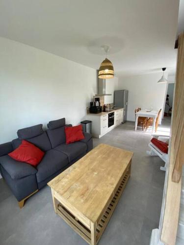 a living room with a blue couch and a table at Le Grand Marguit*** sur la Côte Basco-Landaise in Tarnos