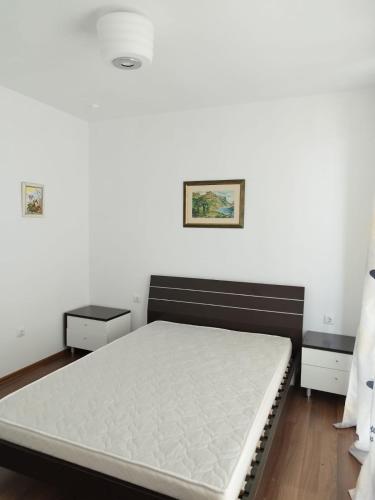 a bedroom with a bed with a white mattress at Belvedere Apartments in Byala