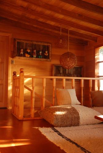 a bedroom with a bed and a wooden wall at OCIO Territorial Hotel in Castro