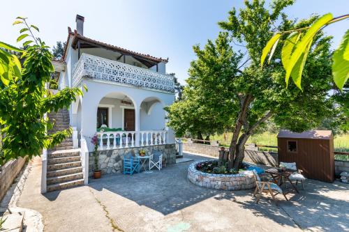 a villa with a view of the garden at Estia A - Studios & Apartments in Skopelos Town