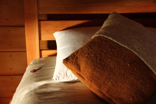 a pillow sitting on top of a bed at OCIO Territorial Hotel in Castro