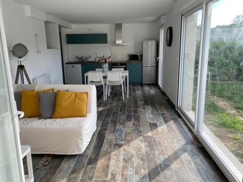 sala de estar con sofá blanco y cocina en Gîte calme au bord de l'Ouche., en Fleurey-sur-Ouche
