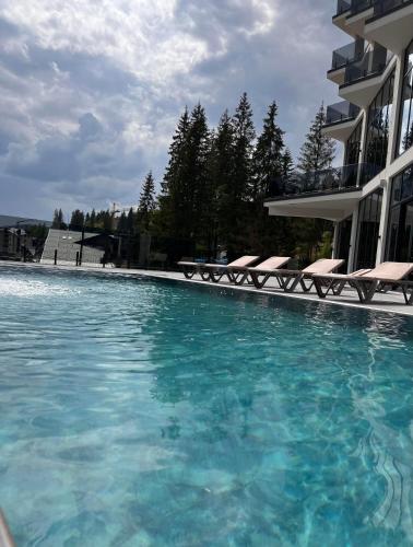 a swimming pool in front of a building at GirskiDelux in Bukovel