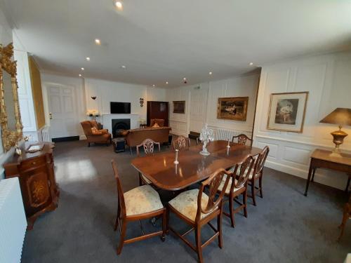 a living room with a wooden table and chairs at Stone Court House in Maidstone