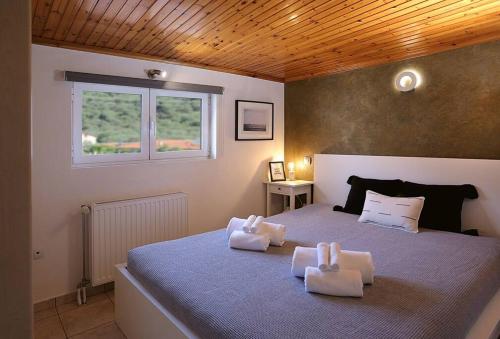 a bedroom with a bed with two towels on it at "Elegant & Quiet House" in Igoumenitsa