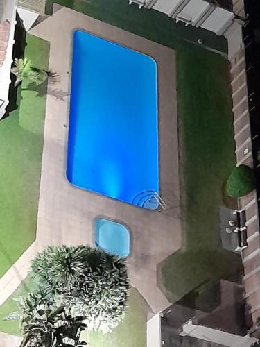 a painting of a house with a blue light at Stella Maris 194 Amazimtoti Self Catering accommodation in Amanzimtoti