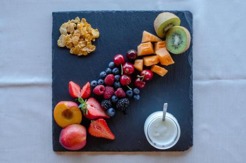 a plate of fruit and a glass of milk at La Minditta in San Teodoro