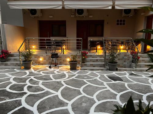 a room with stairs and potted plants and lights at Ethra luxury studios in Asprovalta