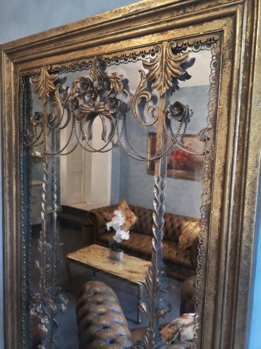 a mirror with a couch and a table in a room at Stone Court House in Maidstone