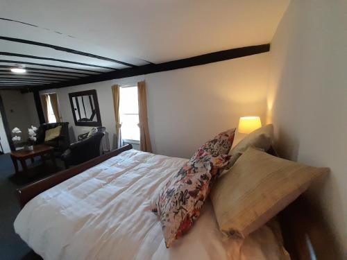 a bedroom with a bed with pillows on it at Stone Court House in Maidstone
