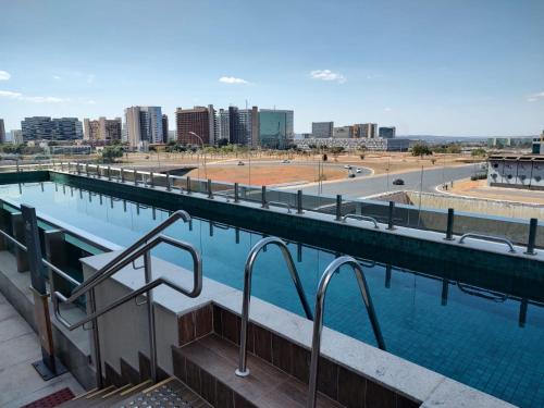 a swimming pool with a view of a city at Ramada by Wyndham Brasilia Alvorada in Brasilia
