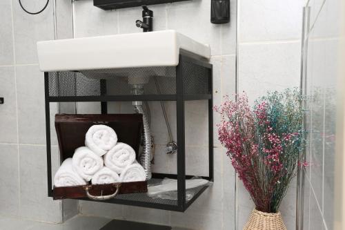a shelf with a basket of towels on a wall at Perazre Hotel in Istanbul