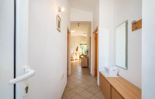 a hallway of a home with a mirror and a sink at Dadić Apartments in Bibinje