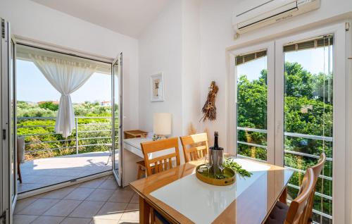a kitchen and dining room with a table and chairs at Dadić Apartments in Bibinje