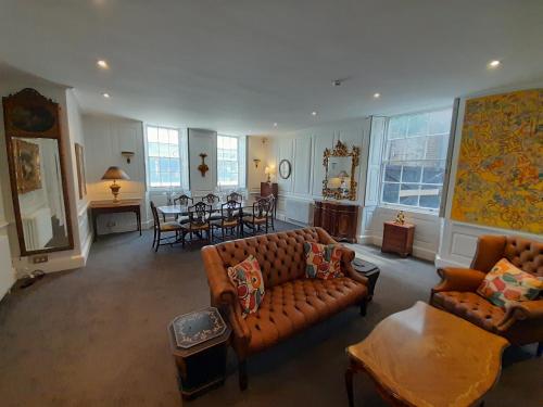 a living room with two couches and a dining room at Stone Court House in Maidstone