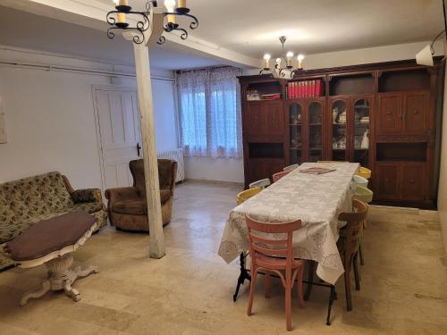 a dining room with a table and a couch at Casa rural L´Amparo -3 espigas- Categoría superior-15 personas in Navarrete del Río