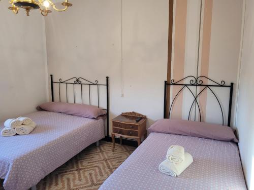 two beds sitting next to each other in a room at Casa rural L´Amparo -3 espigas- Categoría superior-15 personas in Navarrete del Río