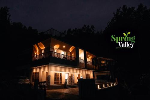 a building at night with a sign that says spring valley at Spring Valley in Anachal