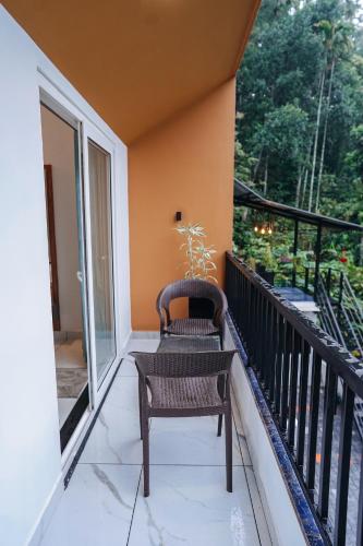 a balcony with a chair and a window at Spring Valley in Anachal