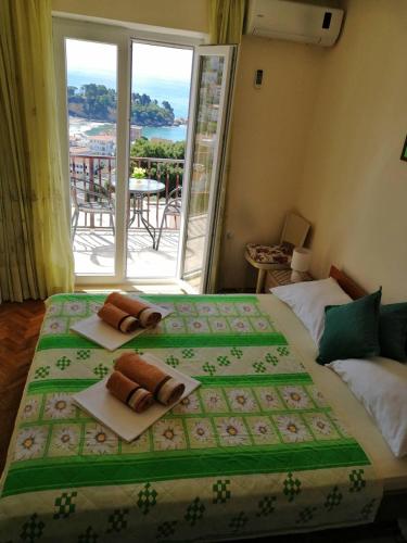 a bedroom with a large bed with towels on it at Apartment Olimp Ulcinj in Ulcinj