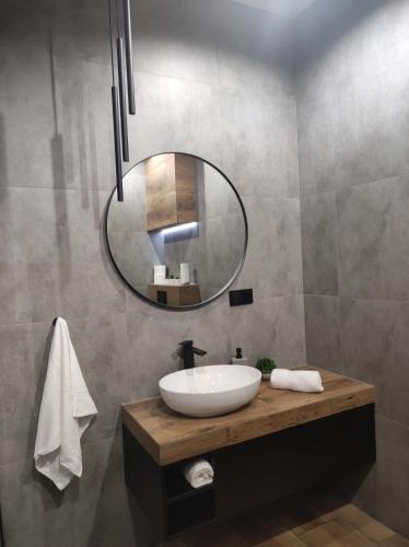 a bathroom with a sink and a mirror at Silver 58 Zator in Zator