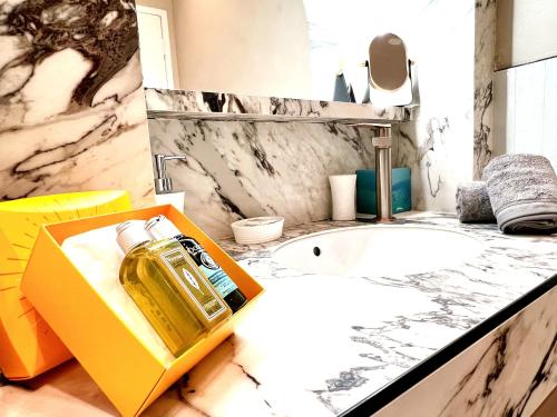 a bathroom with a bottle of perfume on a counter at La LOLA APARTMENT in Cannes