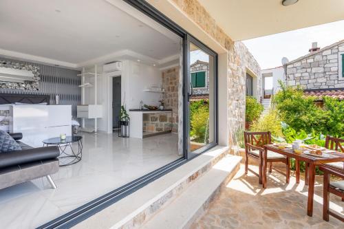 a living room and kitchen with a large glass window at Vidikovac Levanda Luxury Apartments in Hvar