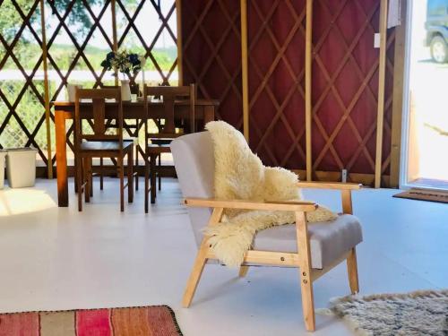 een woonkamer met een stoel en een tafel bij Byron Bay Hinterland Eco-Retreat Terracota Yurt in Eureka