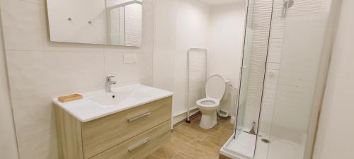 a white bathroom with a sink and a toilet at Studio La ciotat Les Anges du Vieux Port in La Ciotat