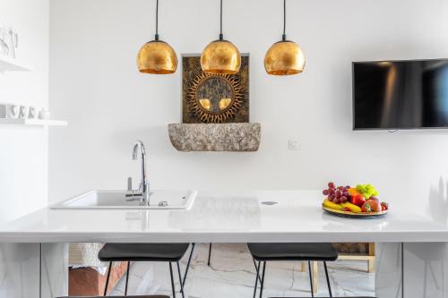 a kitchen with a sink and a bowl of fruit at Vidikovac Levanda Luxury Apartments in Hvar