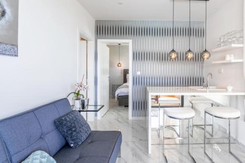 a living room with a blue couch and a table at Vidikovac Levanda Luxury Apartments in Hvar