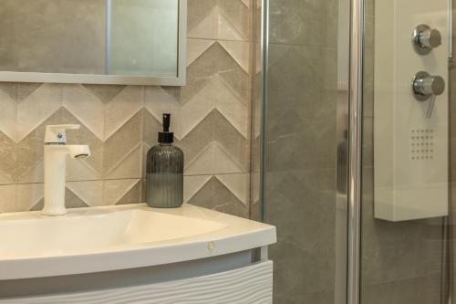 a bathroom with a bottle of wine on a sink at Bol Summer Residence in Bol